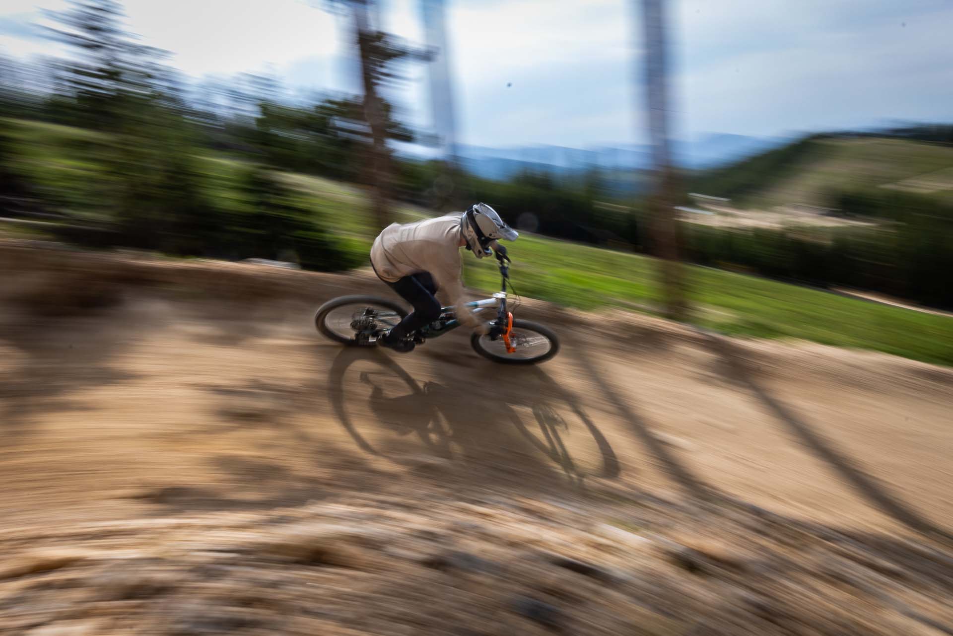 Mountain biker riding a dirt bike track, showcasing the world of RKT Optics.